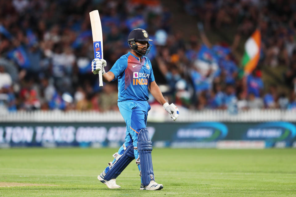 Rohit Sharma raises his bat and celebrates 50 runs during the third Twenty20 cricket match between New Zealand and India.