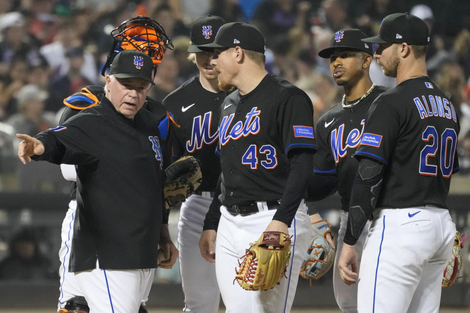 New York Mets manager Buck Showalter, left, removes pitcher Jeff Brigham (43) during the seventh inning of the team's baseball game against the San Francisco Giants, Friday, June 30, 2023, in New York. (AP Photo/Mary Altaffer)