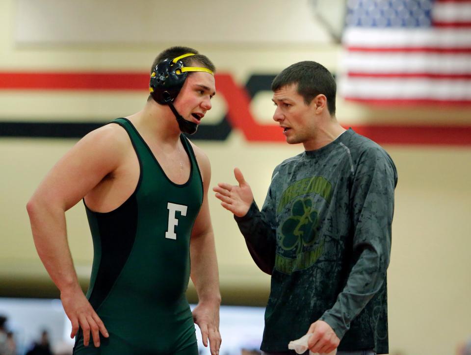 Justin Lancaster, right, coached Freedom to two WIAA Division 2 state team wrestling titles and led the Irish to six conference championships. He took a job with the School District of Holmen on Monday and will be the school's wrestling coach.