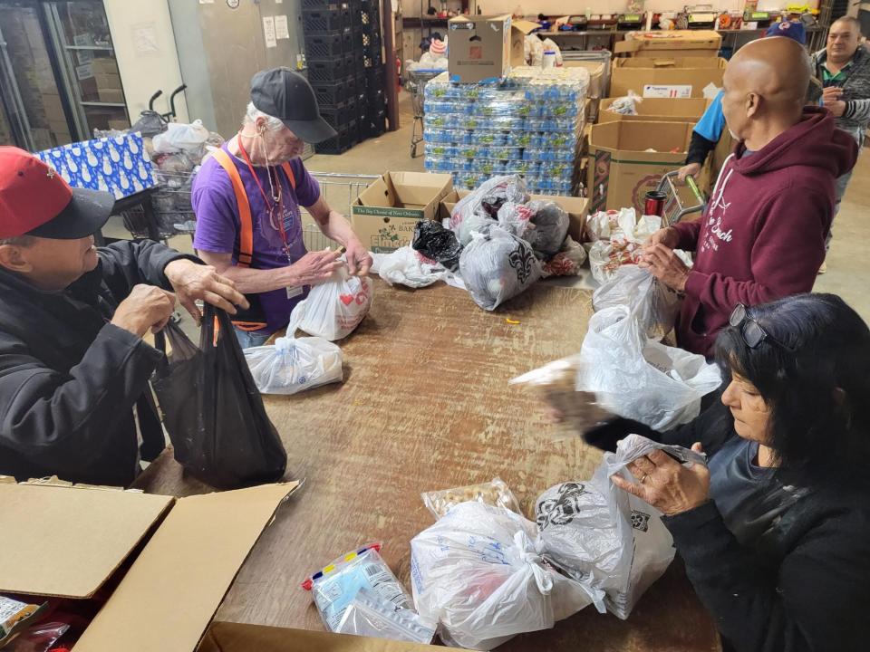 Volunteers fill bags of food at the Terrebonne Churches United Food Bank 922 Sunset Ave, Houma, December 27. From left to right: Ray Allemand, Matt Clearwater, M.J. Roussell, and Connie Blanchard.