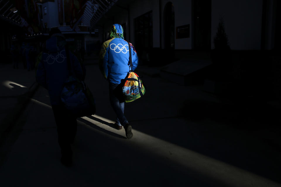 A man walks through the Mountain Olympic Village in Krasnaya Polyana, Russia, prior to the 2014 Winter Olympics, Wednesday, Feb. 5, 2014. The opening ceremony for the games is Feb. 7, and the competition will run until Feb. 23. (AP Photo/Jae C. Hong)