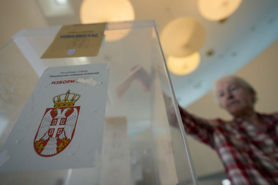 A voter casts her ballot for the local election at a polling station in Belgrade, Serbia, Sunday, June 2, 2024. Voters in Serbia on Sunday are casting ballots in a rerun election in the capital, Belgrade, and in dozens of other cities and towns, with ruling right-wing populists seeking to cement their already vast hold on power. The vote in Belgrade is being repeated after reports of widespread irregularities last December triggered political tensions and accusations that President Aleksandar Vucic's Serbian Progressive Party rigged the vote. (AP Photo/Darko Vojinovic)