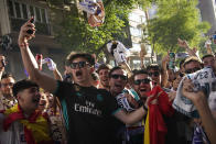 A Real Madrid supporter takes a selfie with other fans before entering to watch the Champions League soccer final on big screens inside the Santiago Bernabeu stadium in Madrid, Spain, Saturday, May 28, 2022. Real Madrid are playing Liverpool in the Champions League final in Paris. (AP Photo/Andrea Comas)