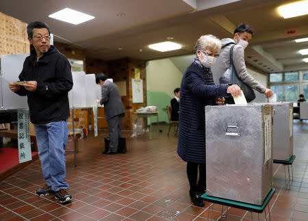 Voters cast their ballots for a national election at a polling station in Tokyo, Japan October 22, 2017. REUTERS/Kim Kyung-Hoon