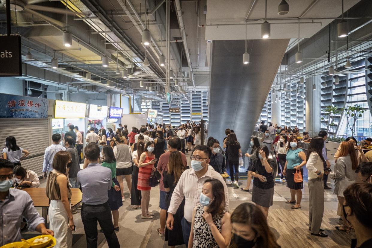 Customers at the Market Street Hawker Centre during lunch hour in Singapore, on Tuesday, April 26, 2022. Photographer: Bryan van der Beek/Bloomberg