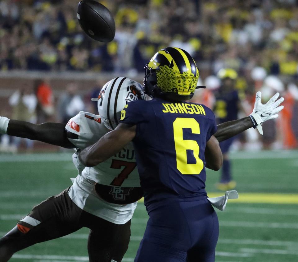 Michigan wide receiver Cornelius Johnson catches a touchdown pass deflected off Bowling Green cornerback Davon Ferguson during the second half of Michigan's 31-6 win on Saturday, Sept. 16 2023, in Ann Arbor.