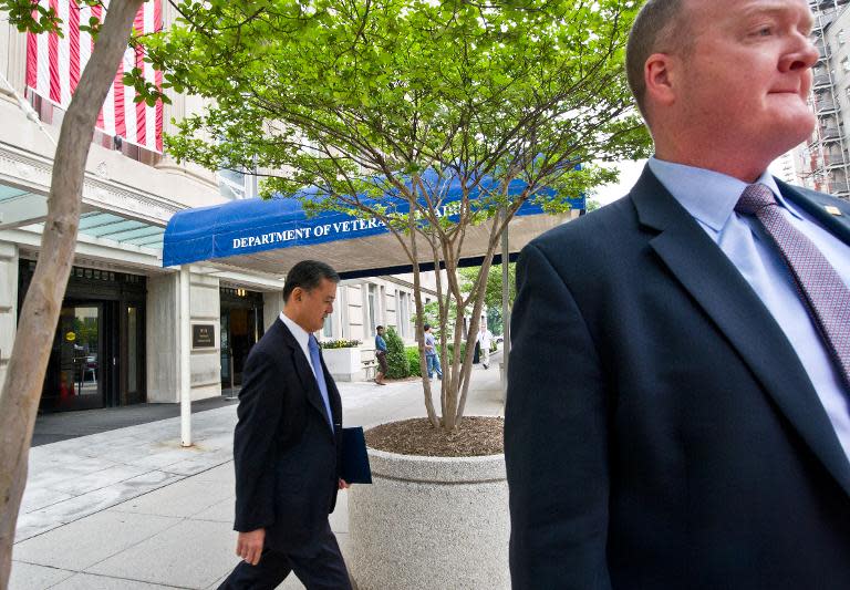 This May 21, 2014 photo shows US Veterans Affairs Secretary Eric Shinseki (L) departing the VA on his way to the White House in Washington