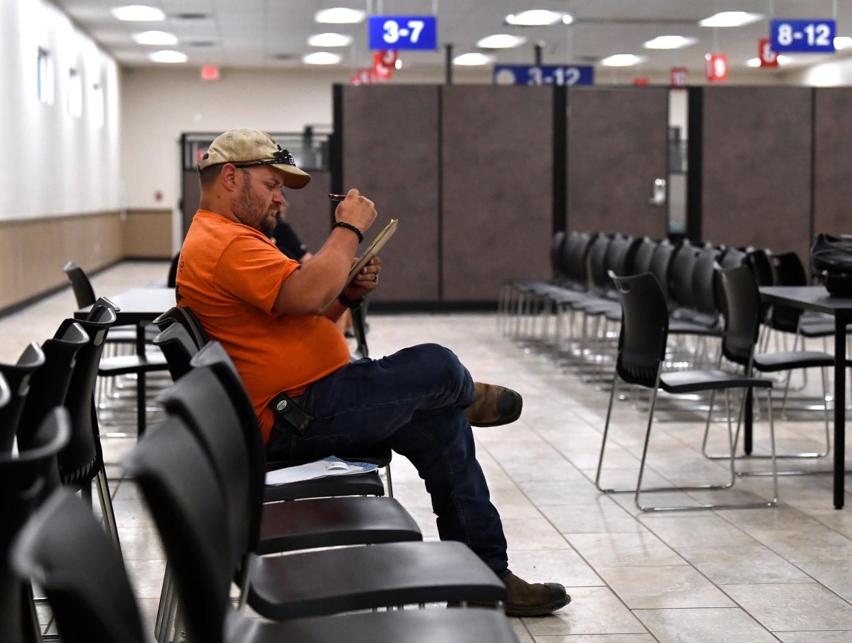 Johnathon Tway fills out a form Tuesday at the Texas Department of Public Safety’s new driver’s license office in north Abilene Tuesday.