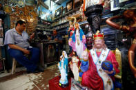 Men sit inside a Christian souvenir shop ahead of Pope Francis’ visit in Cairo, Egypt April 27, 2017. REUTERS/Amr Abdallah Dalsh