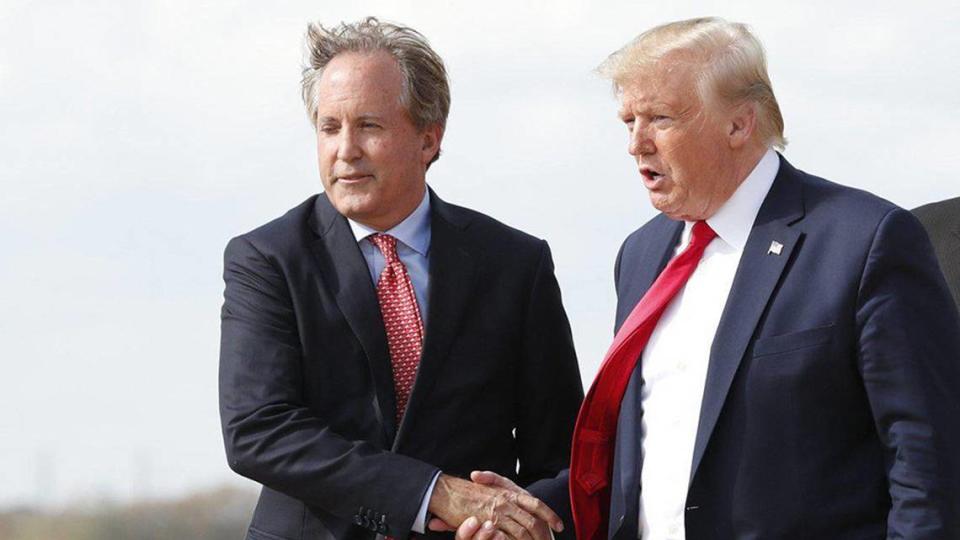 Texas Attorney General Ken Paxton, left, greeting President Donald Trump at Austin-Bergstrom International Airport in November 2019.