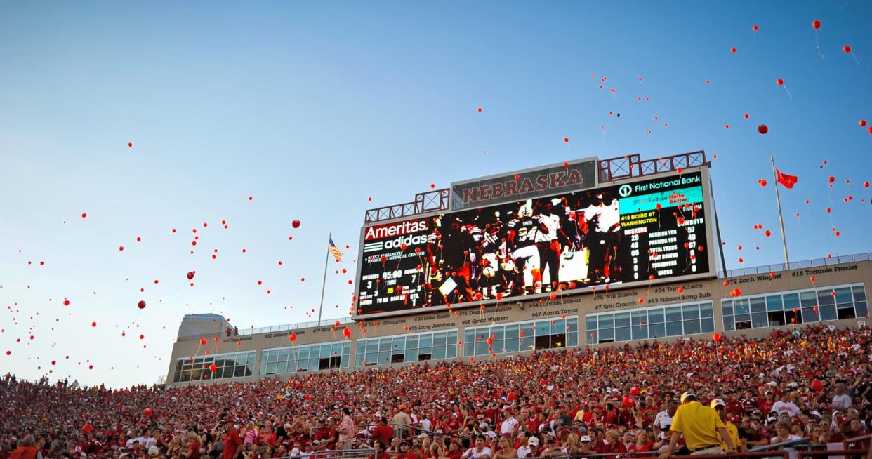 Nebraska fans release red balloons after the Nebraska Cornhuskers score their first points of the game against the Wyoming Cowboys at Memorial Stadium on August 31, 2013 in Lincoln, Nebraska.