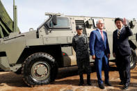 Australian Prime Minister Malcolm Turnbull and Japanese Prime Minister Shinzo Abe stand in front of a Bushmaster military vehicle at Narashino exercise field in Funabashi, east of Tokyo, Japan January 18, 2018. REUTERS/Kim Kyung-Hoon