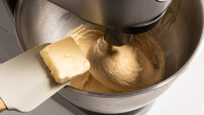 Adding butter to a dough in a stand mixer