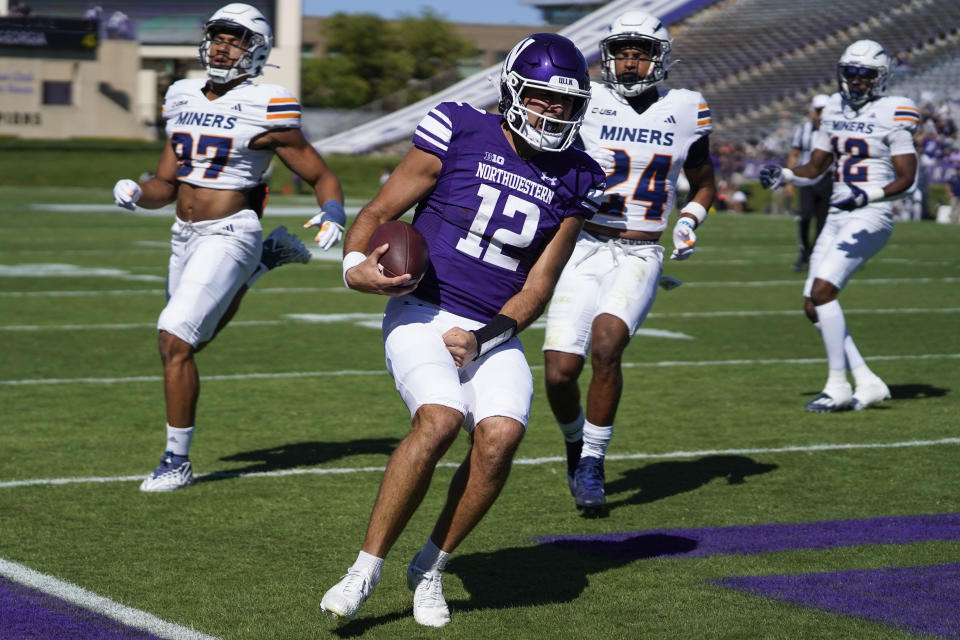 Northwestern quarterback Jack Lausch runs in a touchdown during the first half of an NCAA college football game against UTEP, Saturday, Sept. 9, 2023, in Evanston, Ill. (AP Photo/Erin Hooley)
