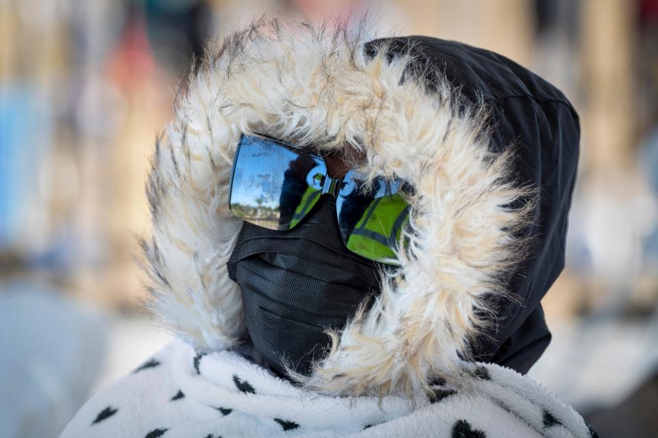 Amya Cleveland keeps warm as she watches the Martin Luther King Jr. Day Parade in Riviera Beach, Florida on January 14, 2023. 