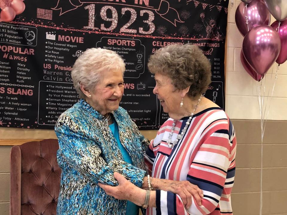 At her 100th birthday celebration, centenarian Arlene Layne Stanton chats with her friend Margaret Reynolds, on the right.