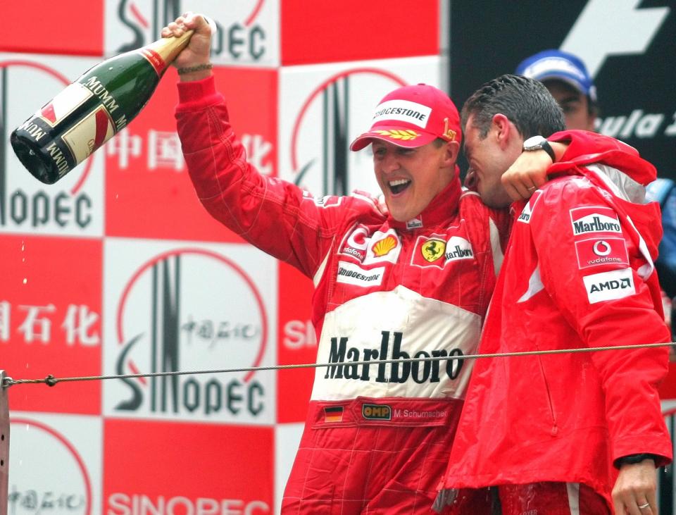 FILE - In this Sunday Oct. 1, 2006 file photo, Germany's Michael Schumacher, left, celebrates his win in the Formula One Chinese Grand Prix with race engineer Chris Dyer, at the Shanghai International Circuit in Shanghai, China.