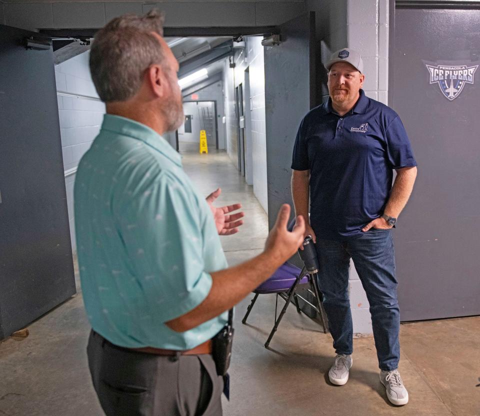 Pensacola Bay Center Executive Director Michael Capps chats with Ice Flyer's owner Greg Harris about the improvements to the facility during a tour on Thursday, Aug. 17, 2023.