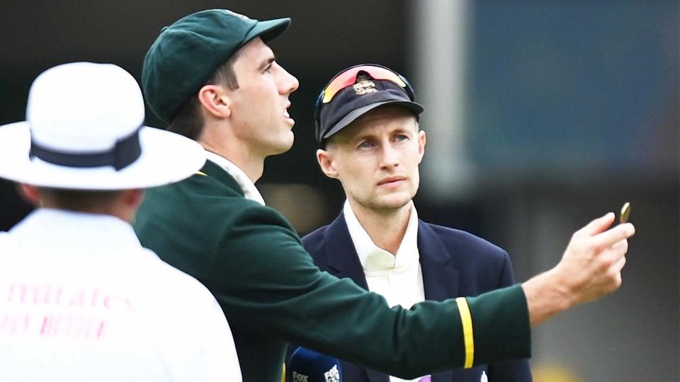 Australian captain Pat Cummins (pictured left) flips the coin in front of England captain Joe Root (pictured right).