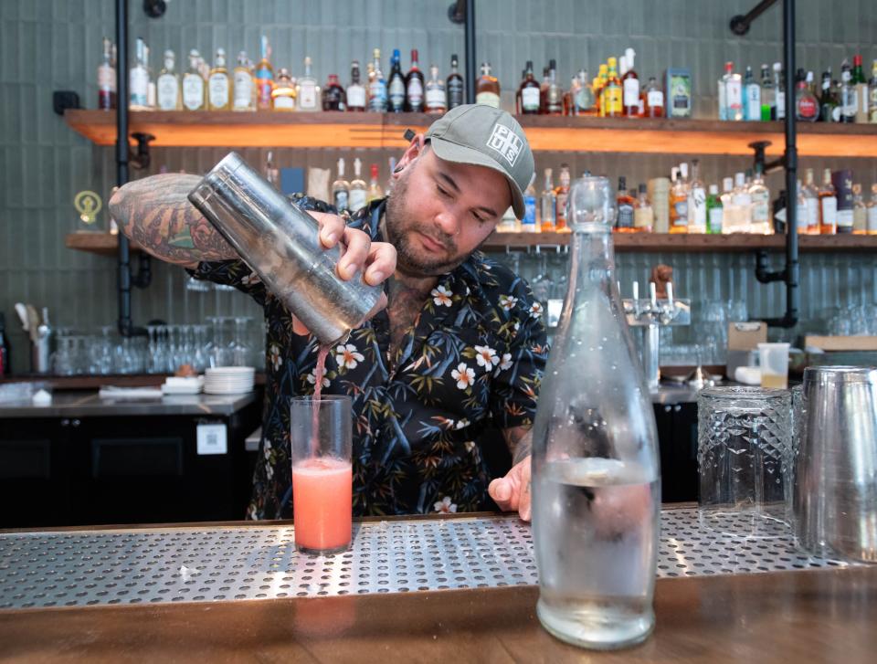 Bartender makes a Blackberry Fizz at the new location of the Union Public House at 36 East Garden Street in Pensacola on Friday, Aug, 25, 2023.