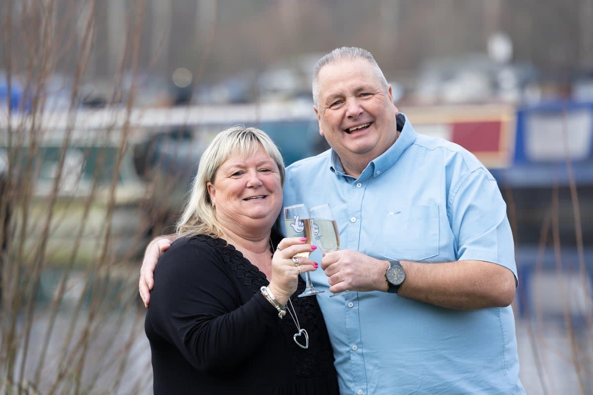 Jeff Etherington and Kim Read toast their £500,000 windfall (National Lottery/PA)