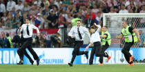 Soccer Football - World Cup - Final - France v Croatia - Luzhniki Stadium, Moscow, Russia - July 15, 2018 Stewards chase pitch invaders REUTERS/Carl Recine