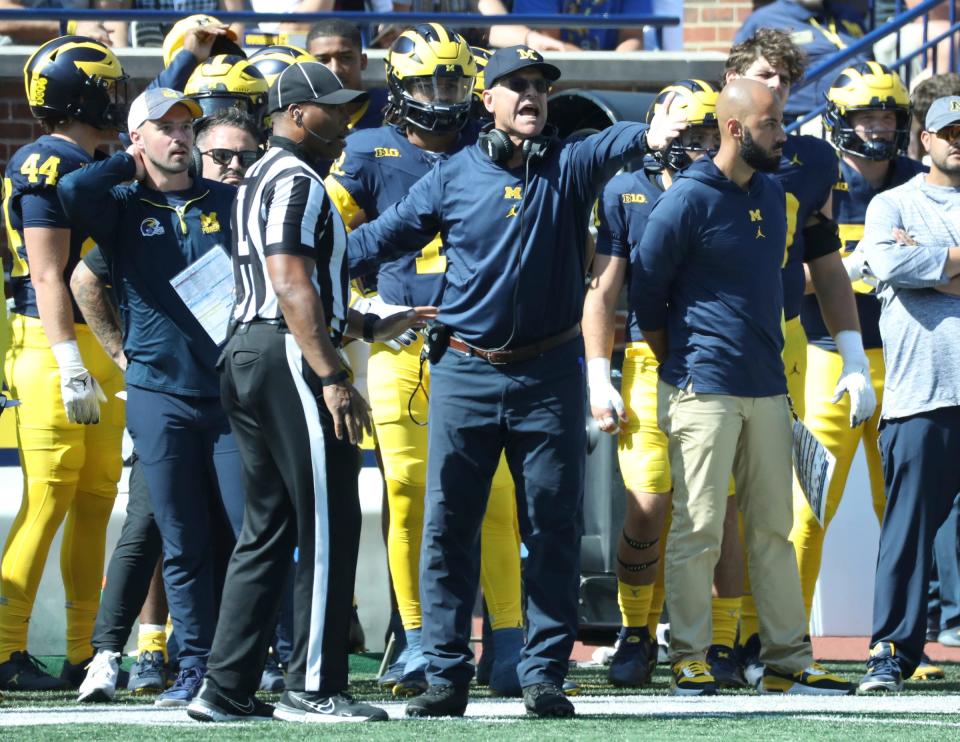 Michigan analyst Connor Stalions, left, next to coach Jim Harbaugh during Michigan's 31-7 win over Rutgers, Sept. 23, 2023 at Michigan Stadium in Ann Arbor.