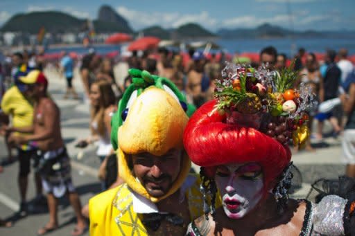 Revelers pose during the Gay Pride Parade at Copacabana beach in Rio de Janeiro, Brazil. Techno music was thumping as tens of thousands hit the streets in Rio Sunday for the annual Gay Pride Parade, which organizers insisted was both a party and political