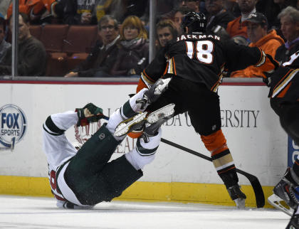 Minnesota Wild center Ryan Carter, left, collides with Anaheim Ducks right wing Tim Jackman during the first period an NHL hockey game Friday, Oct. 17, 2014, in Anaheim, Calif. (AP Photo/Mark J. Terrill)