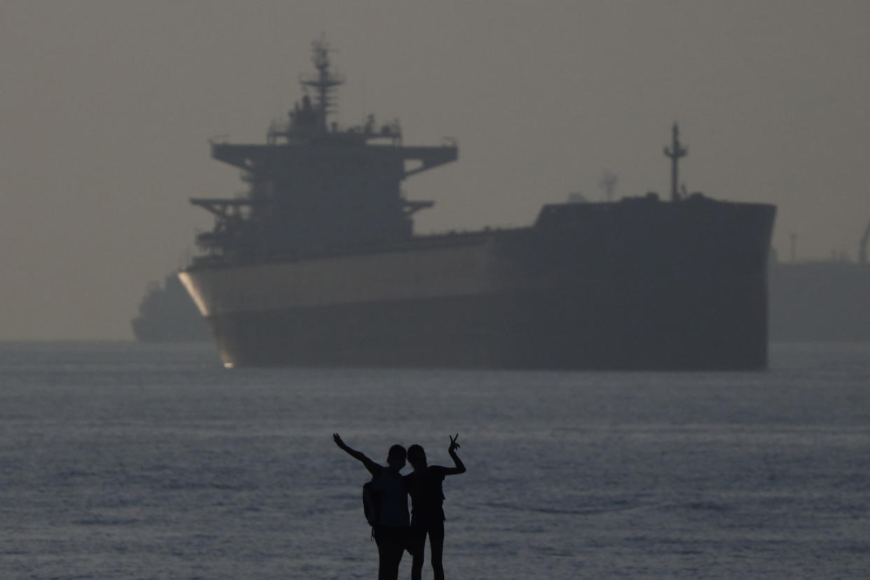 People taking selfie along Singapore's southern coast on 2 April. (PHOTO: Getty Images)