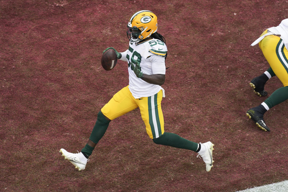 Green Bay Packers linebacker De'Vondre Campbell celebrates in the end zone after his interception for a touchdown during the first half of an NFL football game against the Washington Commanders, Sunday, Oct. 23, 2022, in Landover, Md. (AP Photo/Al Drago)