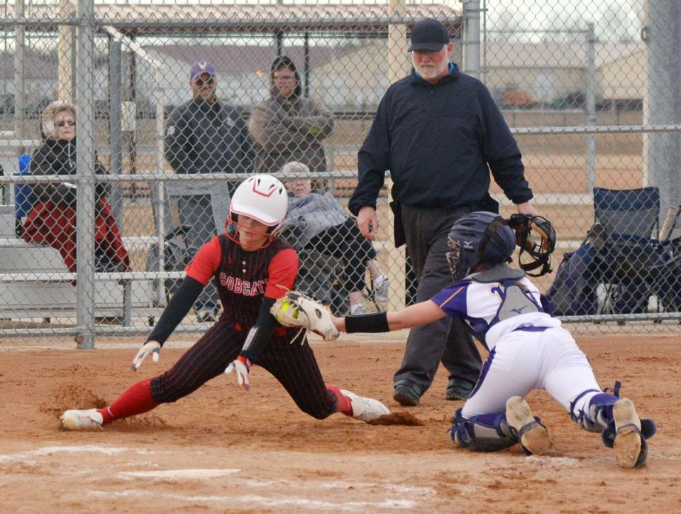 Watertown catcher Emmy Berglund tags out Brookings base runner Kylie Moe at the plate while umpire Travis Young looks on during a high school softball game on Tuesday, April 9, 2024 at the Premier Softball Complex. Brookings won 11-7.