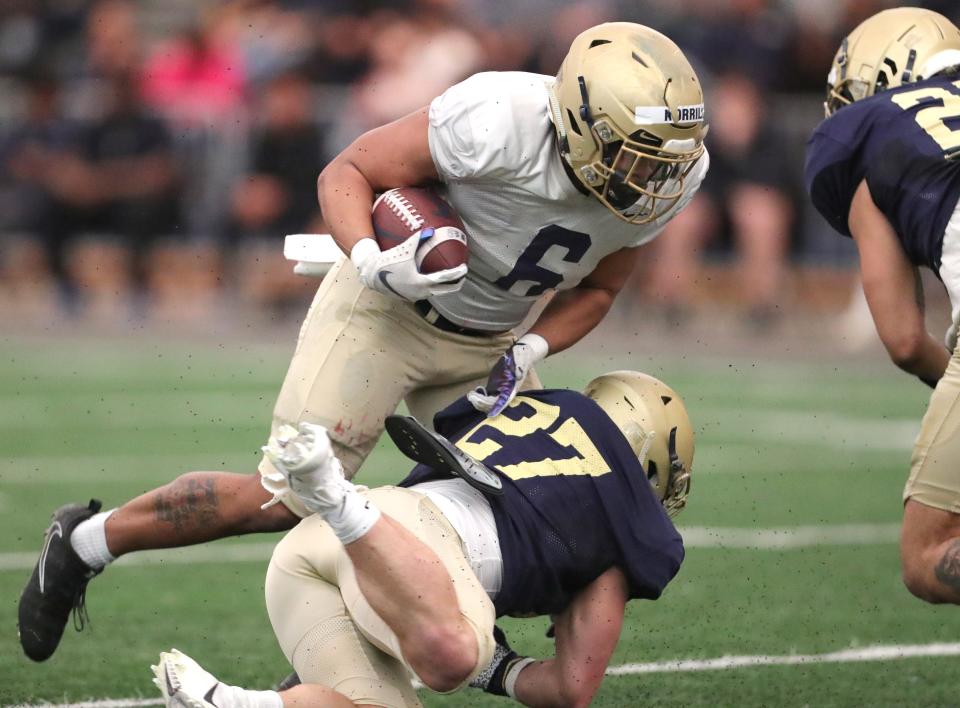 Akron runningback Jonzell Norris is taken down by linebacker Bubba Arslanian during the team's Spring Game on Saturday April 30, 2022 in Akron, Ohio, at Stile Field House.