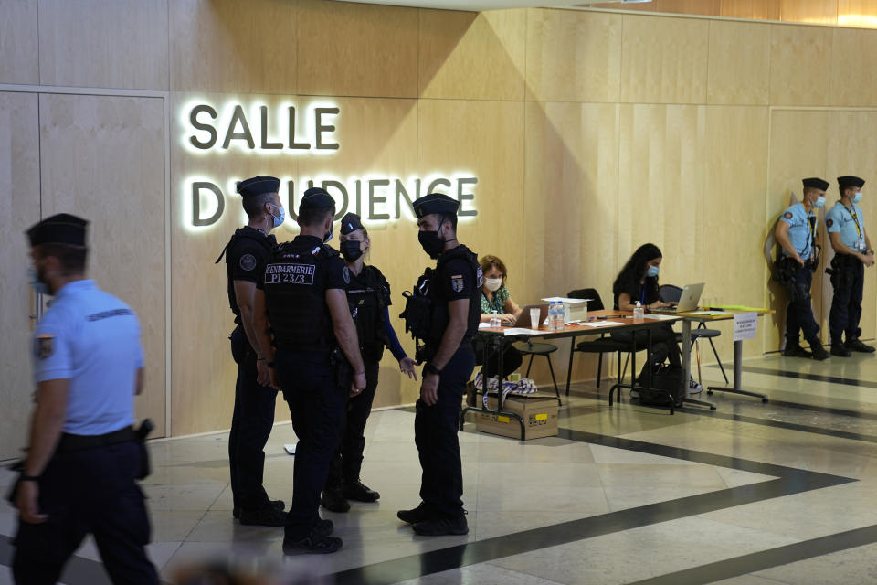 Security forces guard the special courtroom built for the 2015 attacks trial, Wednesday, Sept. 8, 2021 in Paris. France on Wednesday will begin the trial of 20 men accused in the Islamic State group's 2015 attacks on Paris that left 130 people dead and hundreds injured. Among the plantiffs are nearly 1,800 victims, including survivors who suffered physical or psychological harm and families whose loved ones died that night. A total of 330 lawyers are representing them and the defendants. (AP Photo/Michel Euler)