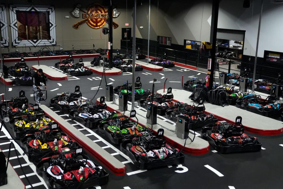 Karts in the pit area recharge for the next field of racers.