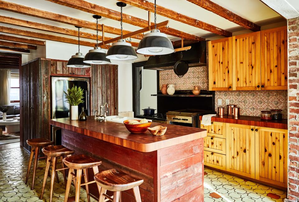 The kitchen features reclaimed wood.