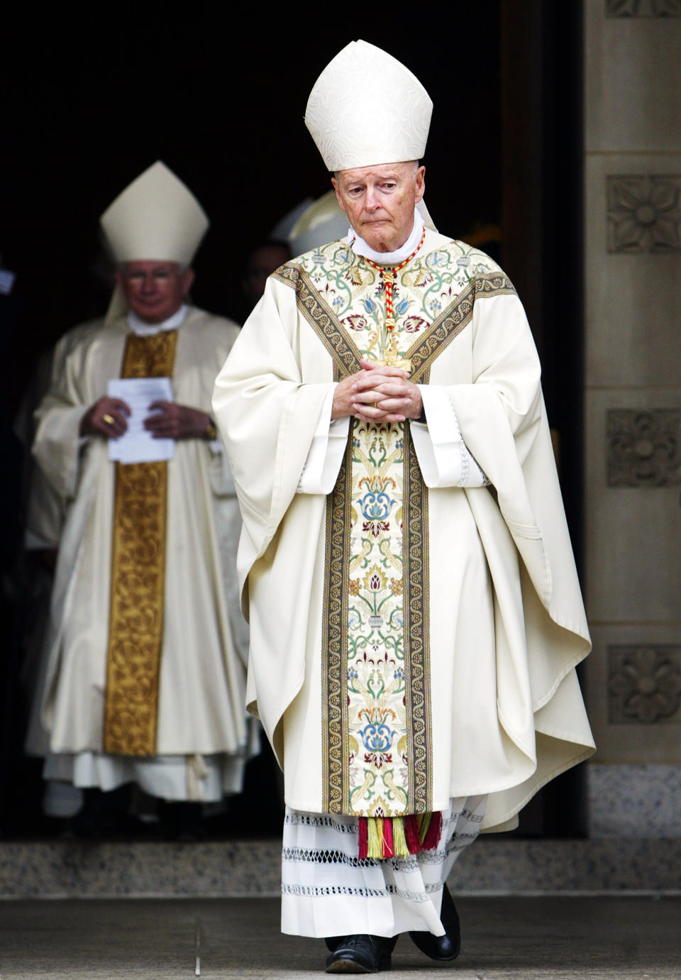 FILE - In this Oct. 30, 2004 file photo, Cardinal Theodore E. McCarrick, leads a procession of priests, bishops and cardinals after a Mass of Christian Burial for Cardinal James A. Hickey at the Basilica of the National Shrine of the Immaculate Conception in Washington. On Tuesday, Nov. 10, 2020, the Vatican is taking the extraordinary step of publishing its two-year investigation into the disgraced ex-Cardinal McCarrick, who was defrocked in 2019 after the Vatican determined that years of rumors that he was a sexual predator were true. (AP Photo/Manuel Balce Ceneta, File)