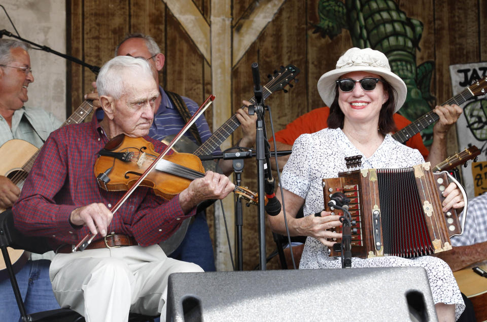 FILE - In this April 30, 2011 file photo, members of the Savoy Music Center of Eunice Saturday Cajun Jam respond to the crowd while performing at the Louisiana Jazz and Heritage Festival in New Orleans. April marks the start of spring festival season in south Louisiana. As the revelry of Mardi Gras and chill of winter end, spring festivals usher in the flip-flops, floppy hats and folding chairs toted by music lovers from across the globe. French Quarter Festival and Jazz Fest in New Orleans, and Festival International de Louisiana in Lafayette, La., are all held in April. Other Louisiana festivals held in spring and summer include Bayou Country Superfest in May, New Orleans Cajun-Zydeco Festival in June, Essence Music Festival in July and Satchmo Summerfest in August. (AP Photo/Gerald Herbert, File)