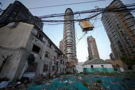 Electric wires hang above a demolished old house at Guangfuli neighbourhood, in Shanghai, China, April 19, 2016. REUTERS/Aly Song