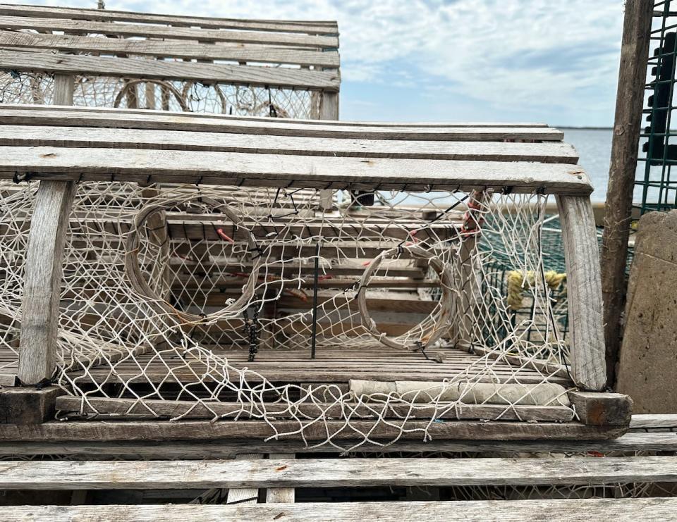 One of Charles Francis's traps stacked on the wharf in Louisbourg shows signs of vandalism with the mesh cut all along the side.