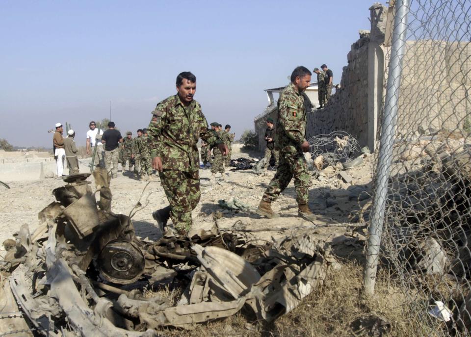 Afghan National Army (ANA) soldiers investigate the site an attack on a joint NATO-Afghan base in the Ghani Khel district of Nangarhar