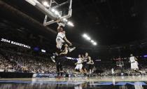 Michigan State’s Travis Trice (20) dunks against Harvard in the first half during the third-round game of the NCAA men's college basketball tournament in Spokane, Wash., Saturday, March 22, 2014. (AP Photo/Young Kwak)
