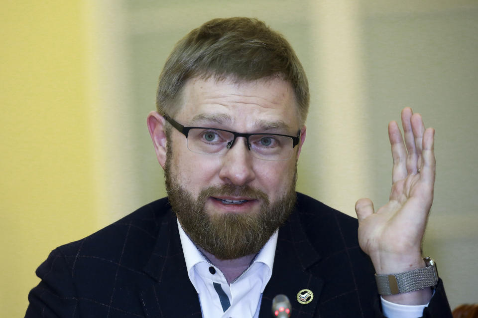 In this Thursday, April 19, 2018, photo, 'USA Really' editor Alexander Malkevich gestures while speaking at the plenary meeting of the forum "Society, Culture and Media" in St. Petersburg, Russia. As Americans prepare for another election, Russian troublemakers appear to laboring afresh to divide U.S. voters and discredit democracy, and perhaps even sway the outcome. (Svetlana Kholyavchuk/Interpress Photo Agency via AP)