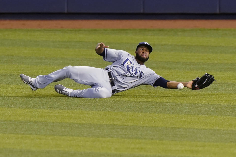 Tampa Bay Rays right fielder Manuel Margot is unable to catch a ball hit by Miami Marlins' Jonathan Villar for a single during the first inning of a baseball game Saturday, Aug. 29, 2020, in Miami. (AP Photo/Wilfredo Lee)