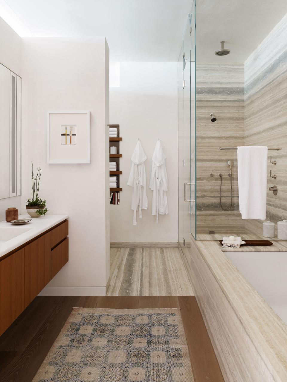 The master bath is a study in stone. Santos carefully chose travertine with a blue hue that flows perfectly to create a water-like effect.