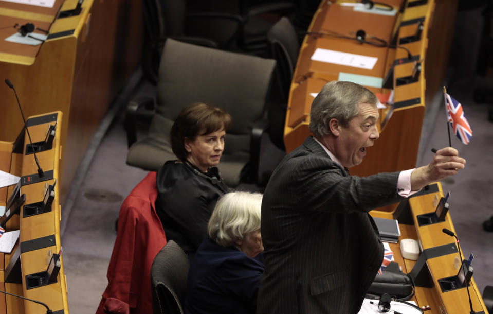 FILE - In this Wednesday, Jan. 29, 2020 file photo, Brexit Party leader Nigel Farage waves the Union flag ahead of a vote on the UK's withdrawal from the EU during the plenary session at the European Parliament in Brussels. Across the English Channel, Brexit supporters in British politics and the media often depict a conniving EU, deeply hurt by the U.K.'s decision to leave, and doing its utmost to make Brexit less than a success by throwing up bureaucratic impediments. (AP Photo/Virginia Mayo, File)