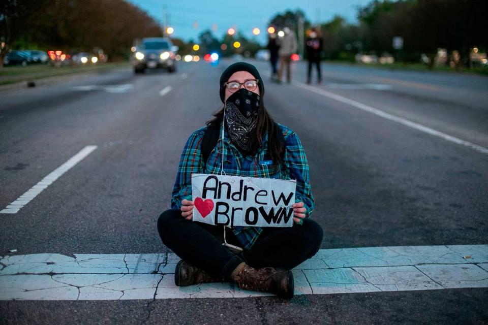 Kat Kidd blocks the intersection of Ehringhaus Street and Halstead Blvd. during a demonstration and march on Thursday, April 22, 2021 in Elizabeth City, NC, in reaction to the death of Andrew Brown Jr., who was shot by a Pasquotank County Deputy Sheriff on Wednesday. The march drew nearly 300 participants and lasted about three hours.