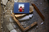 A picture and broken frame lay in the debris in an apartment after it was hit by a rocket fired from the Gaza Strip over night, in Petah Tikva, central Israel, Thursday, May 13, 2021. (AP Photo/Oded Balilty)