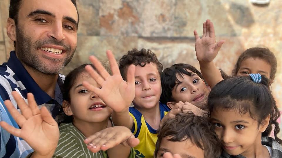 Al-Naizi with some of the children from the orphanage outside their new shelter, on November 9. - Hazem Saeed Al-Naizi