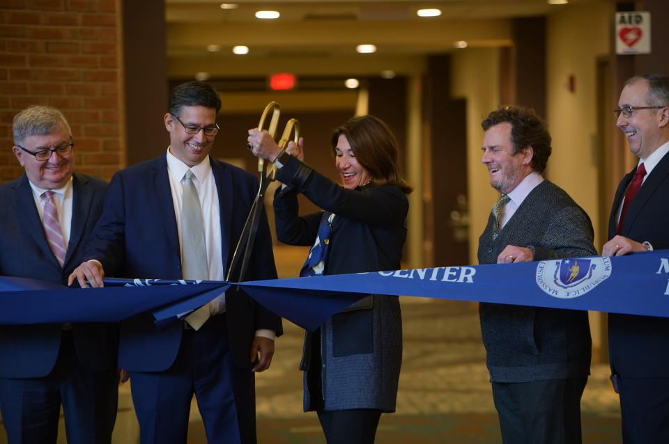 Lt. Gov. Karyn Polito maneuvers a giant pair of scissors during a ribbon-cutting ceremony for the Massachusetts Municipal Police Training Center at the Southbridge Conference Center.